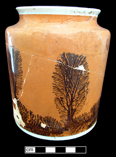 Pitcher with green-glazed rilling or reeding at top and bottom and engine-turned pattern.
